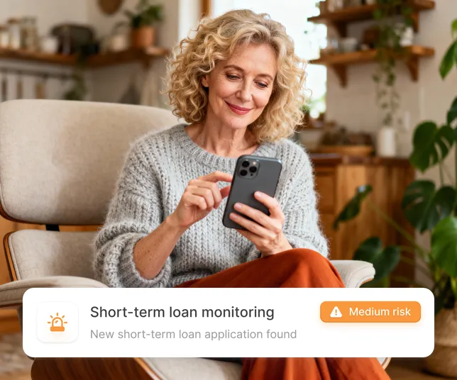 A woman using a smartphone to check for short-term loan monitoring alerts.
