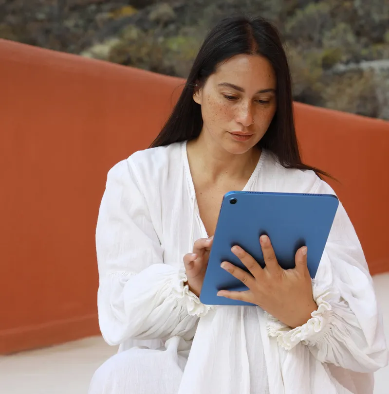 A woman receives a NordProtect security alert on her device.