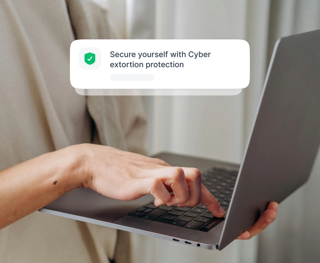 A person using a laptop to purchase NordProtect’s cyber extortion coverage.