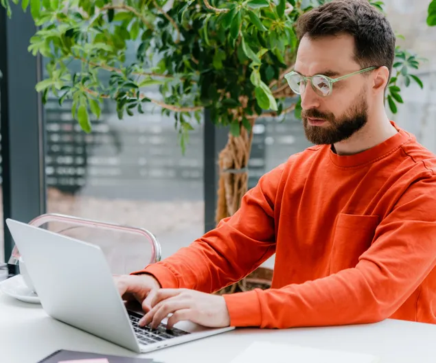 A man checks NordProtect’s identity theft recovery coverage options on his computer.